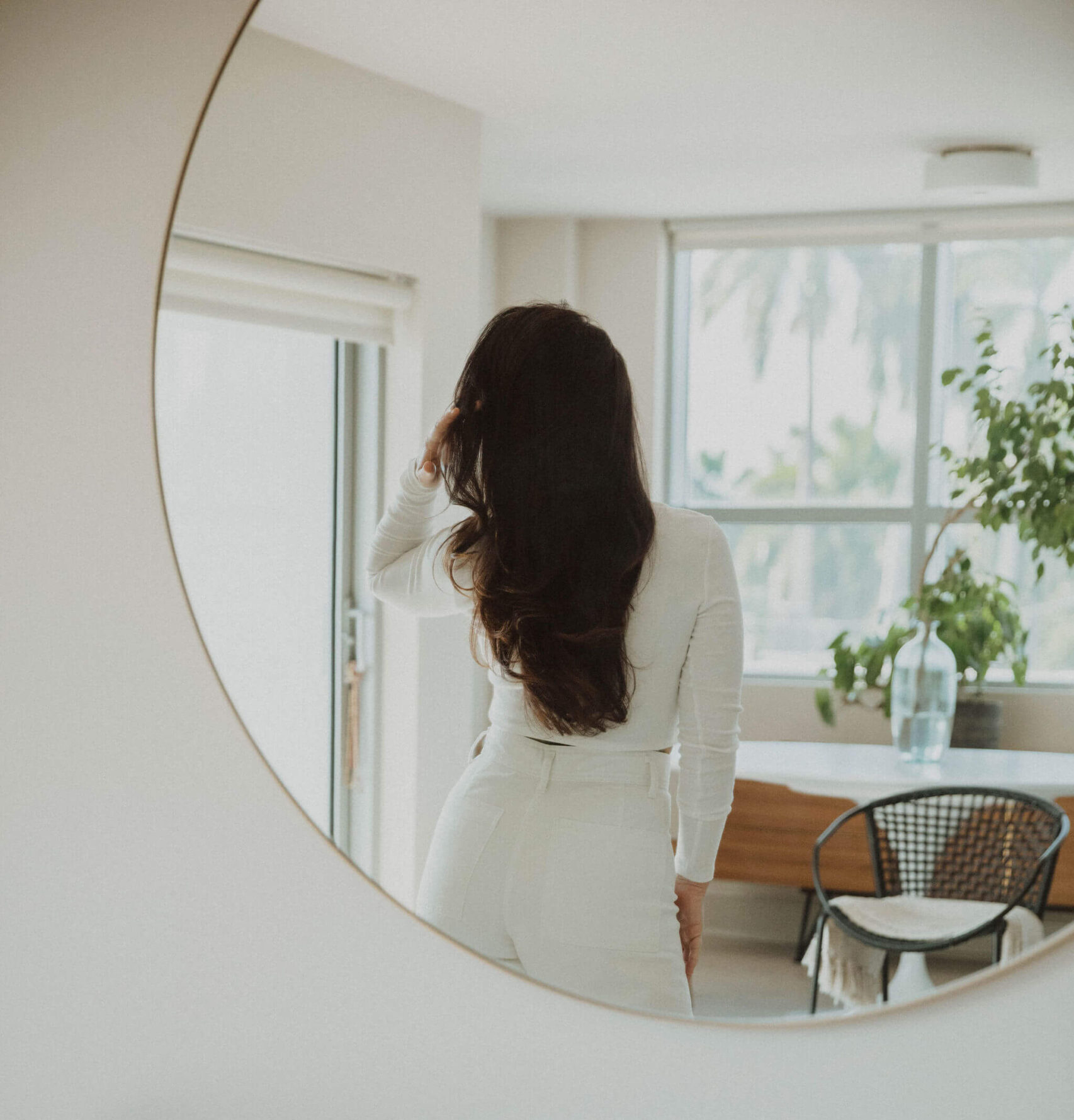 woman with long hair in mirror.
