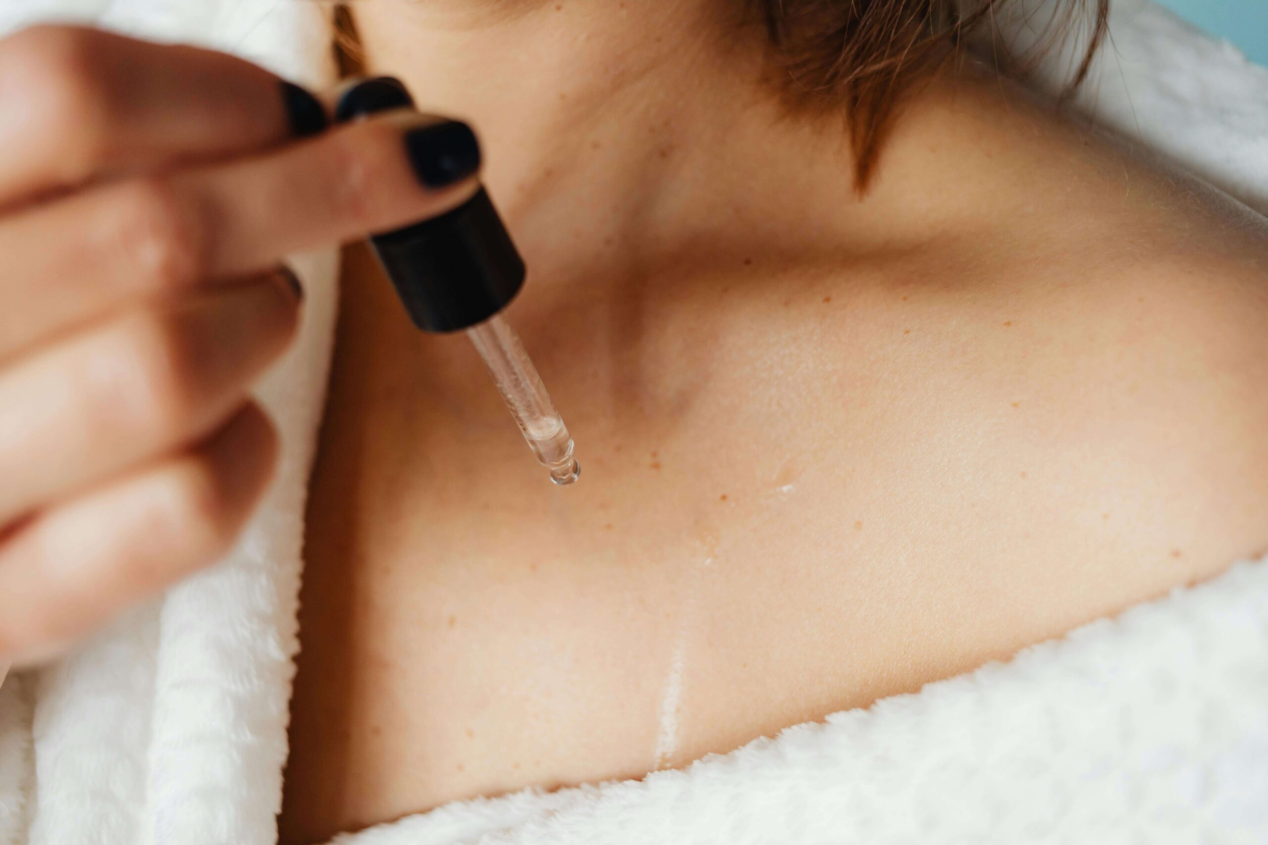woman applying facial oil